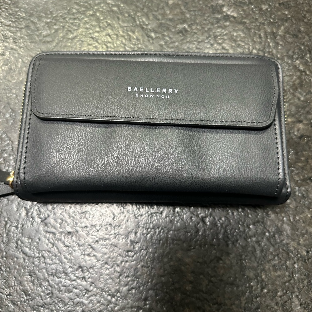Black cross- body purse.  It has multiple compartments.  New in bag.